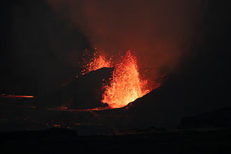 Night-time view of the eruption (lava fountains) from two vents and edge of lava pool in Halemaumau Crater as seen from the Crater Rim Trail (after dark). (Zoom view)